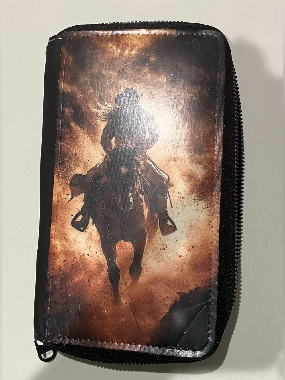 Western-themed zip-around wallet cowboy riding horse sunset